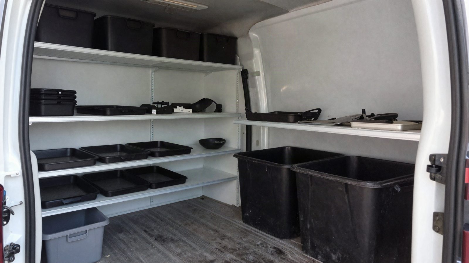 The inside of a service van fitted with parts shelving