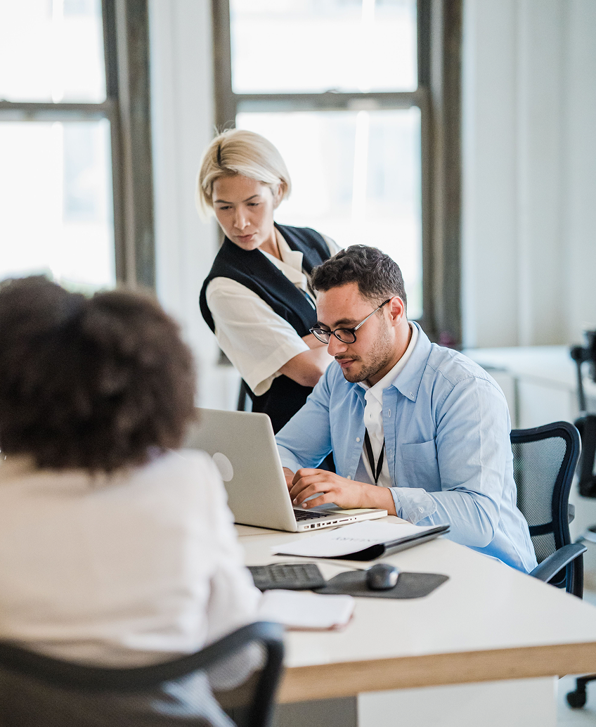 Customer team reviewing a purchase on a laptop