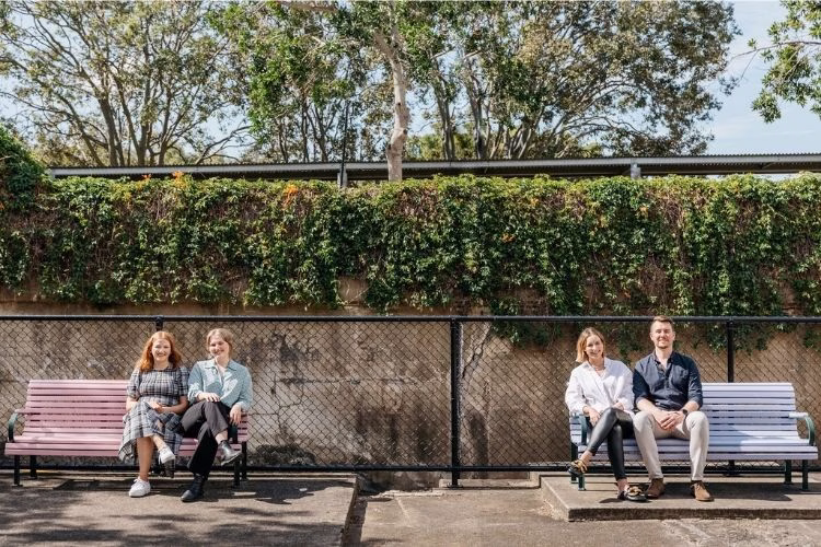 HR team sitting in park bench