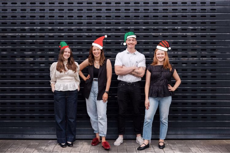 HR Team wearing cartoon Christmas hats for the end of year season