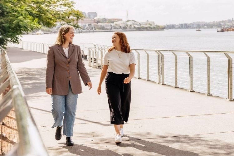 Two team members going for a lunch time walk along the Brisbae river