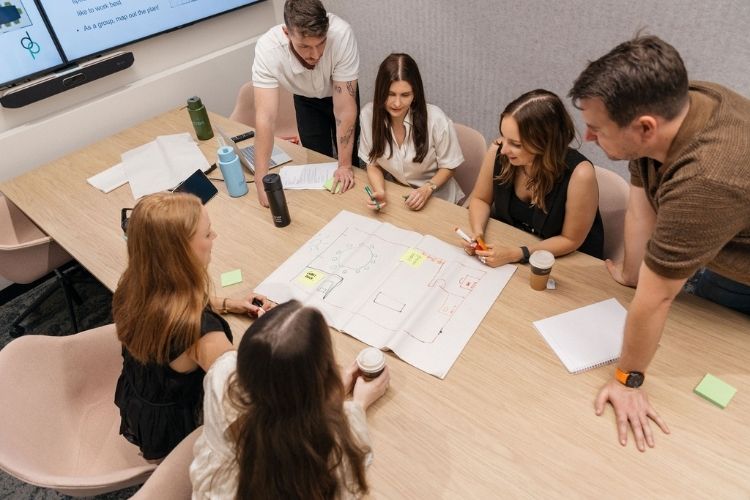 A workplace team of seven working together on brainstorming activity,