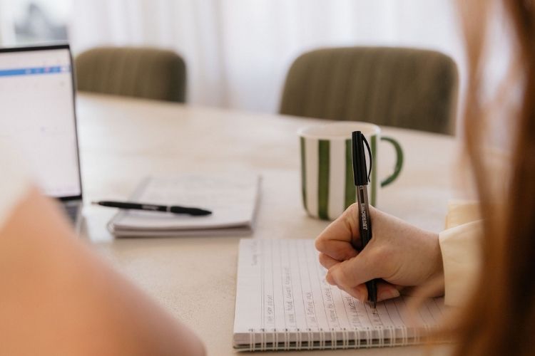 HR consultant checklist in notebook of key changes for small businesses