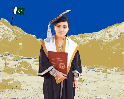 Graduate woman in cap and gown holding a diploma with a Pakistani flag on a rocky hill behind her.