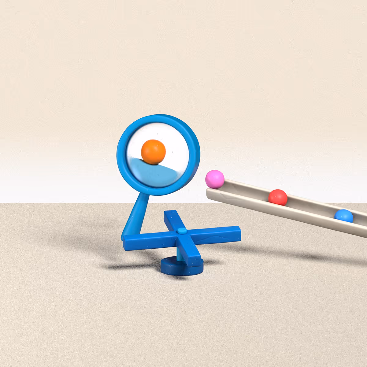 Blue magnifying glass showing enlarged orange ball near a tray with pink, red, and blue balls.
