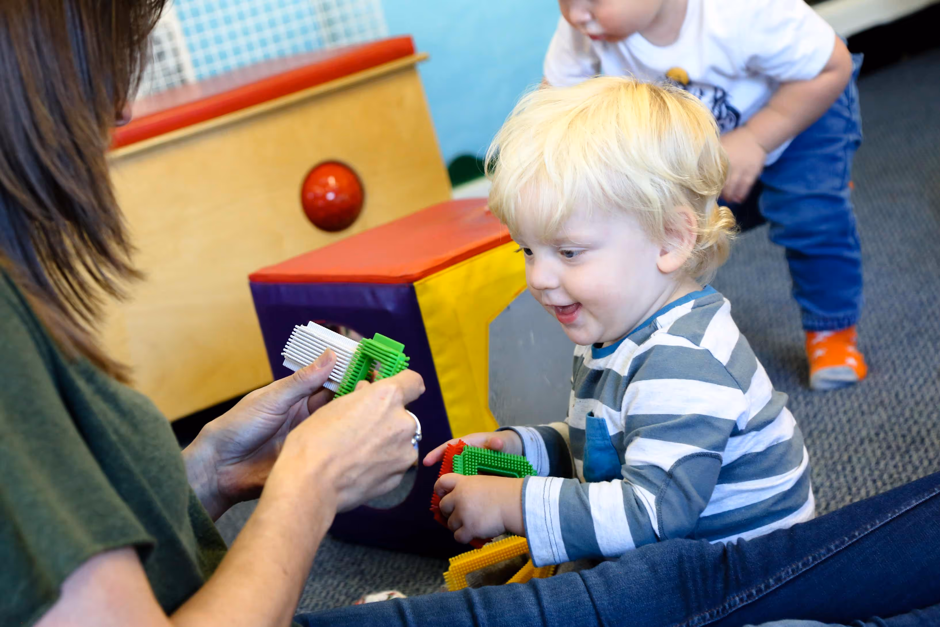 Teacher showing child a game