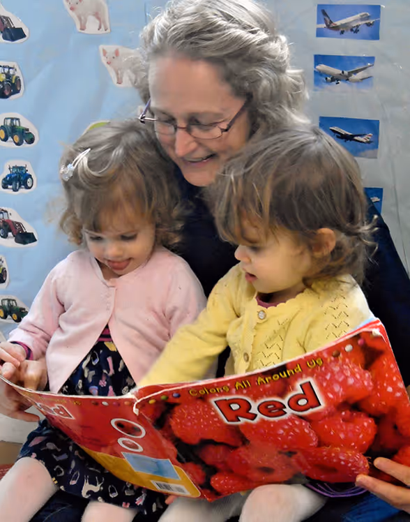 Teacher reading to two children