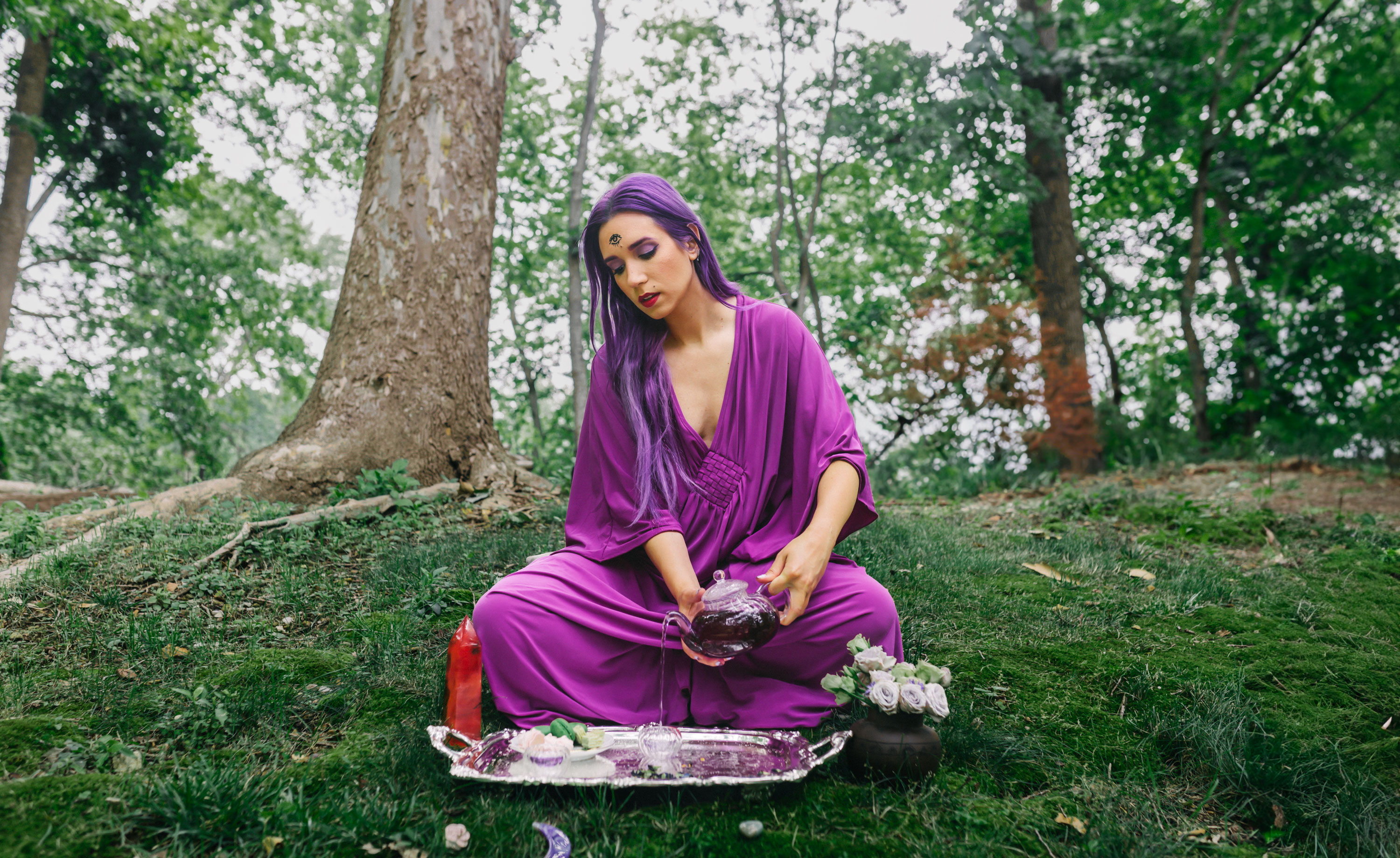 Artist Anastasia Elliot Pouring Purple tea into glass