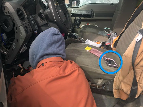 Photo of an install technician doing his thing. The Installer app has been started and tossed onto the driver seat for later reference.