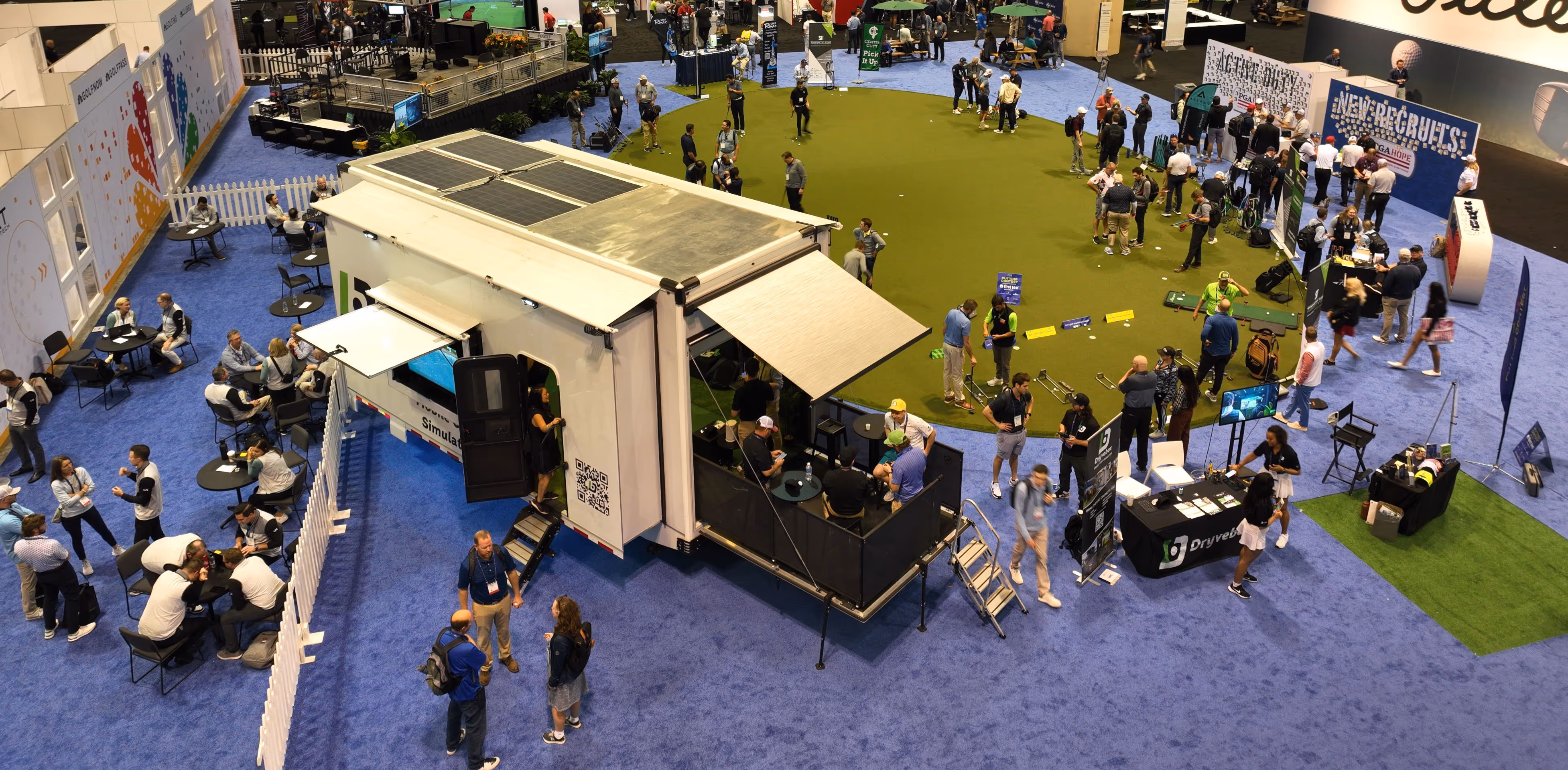 overhead drone shot of a golf simulator at a trade show