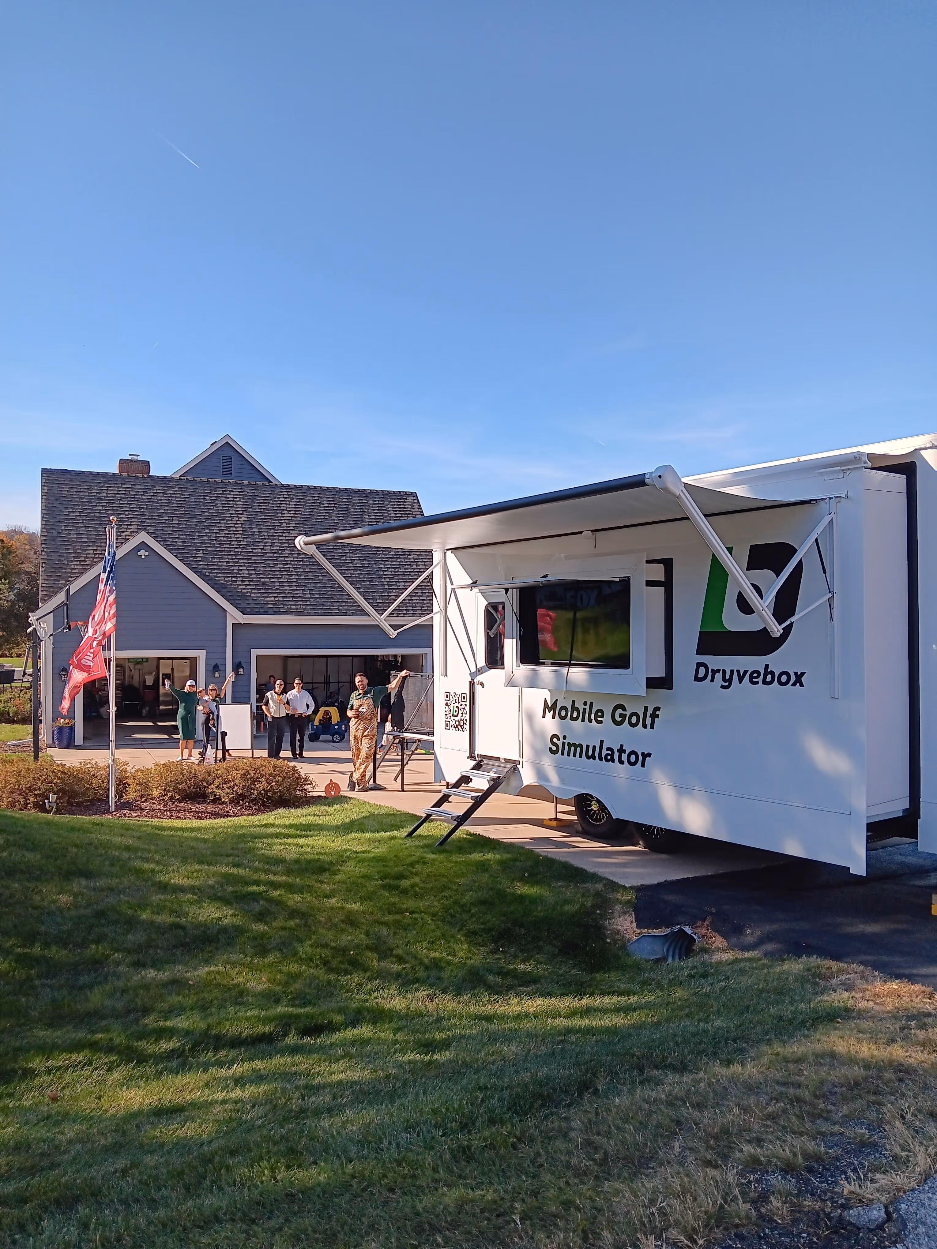 Mobile golf simulator set up at an outdoor event. Indoor pop-up golf simulator set up at a venue. 