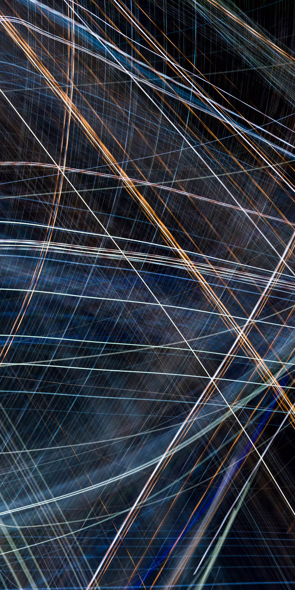 A long-exposure nighttime photograph of a city skyline, with colorful light trails arcing over the buildings, creating an abstract and surreal visual effect.