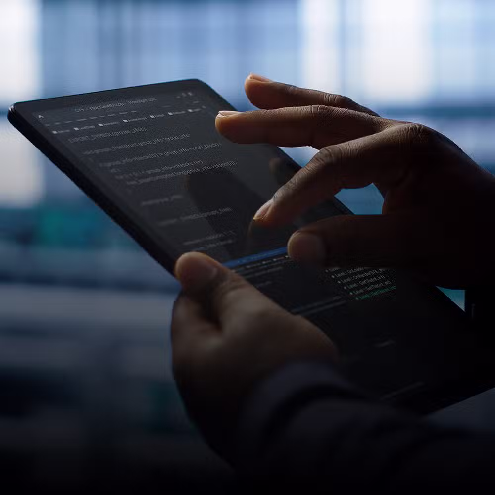 A futuristic digital tablet projects holographic blue and red data nodes above its surface. The interface appears immersive, resembling a virtual control panel with glowing lights and digital pathways.