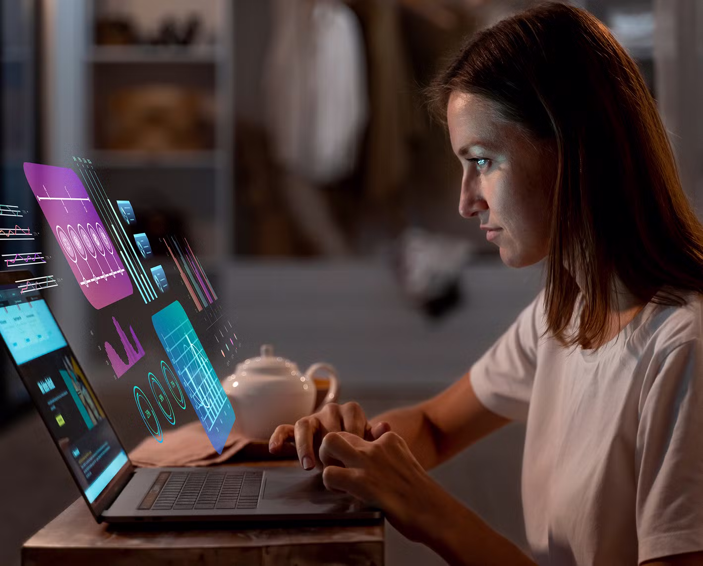 A man working at a deck on a laptop computer.