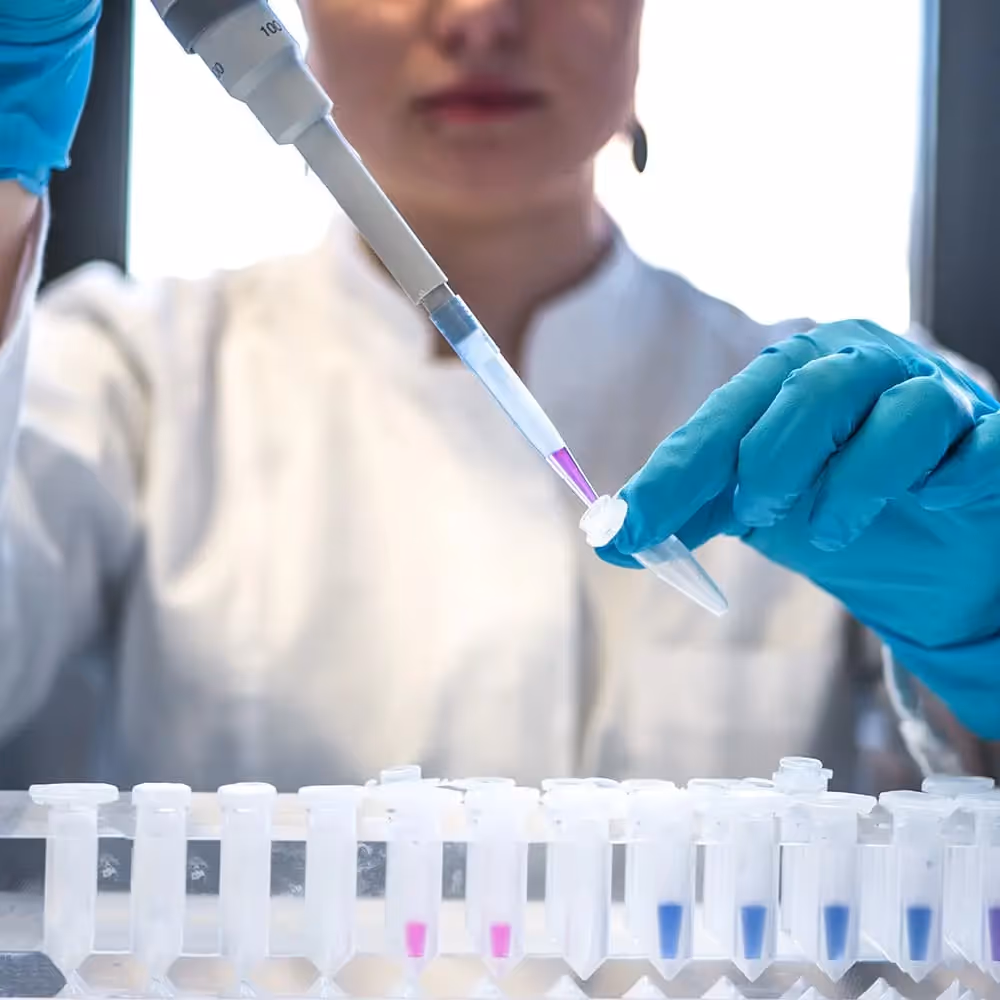 A woman using a machine in a lab setting.