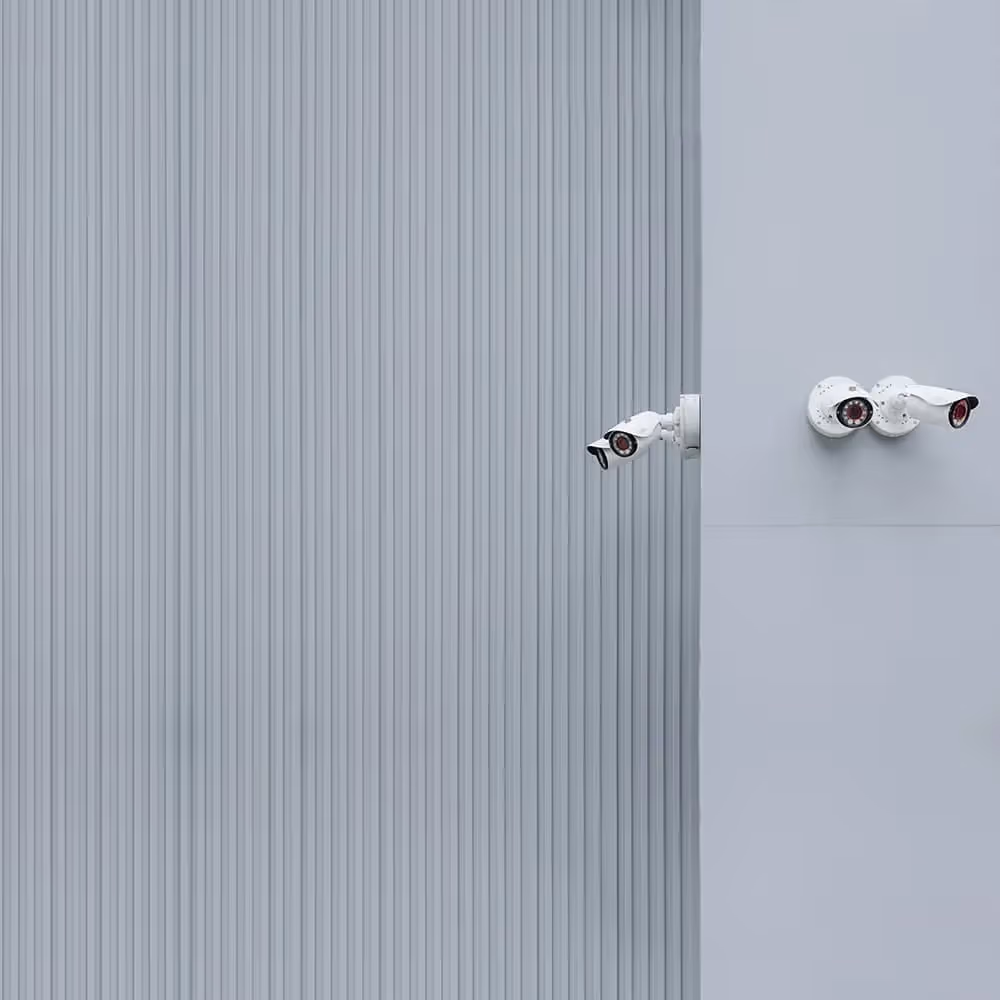 Security cameras overlooking a street.