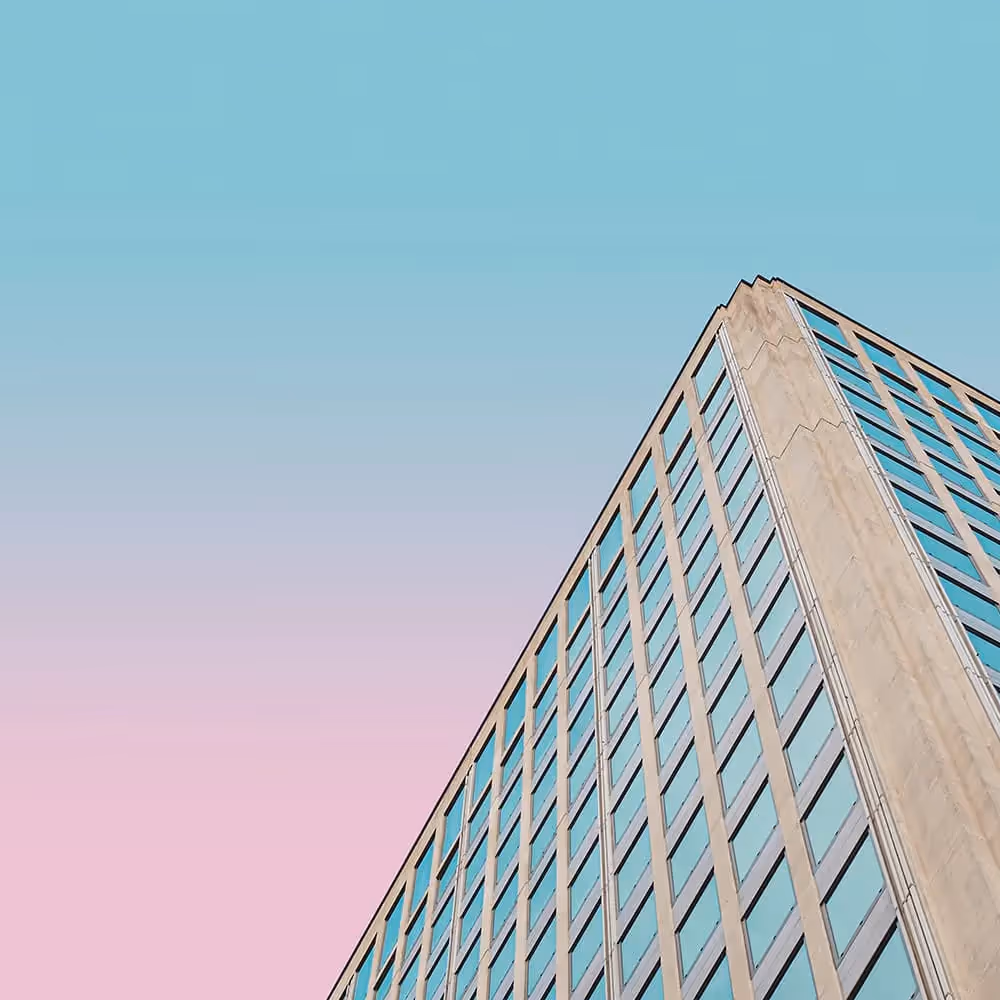 A large building with a blue and pink colored skyline.