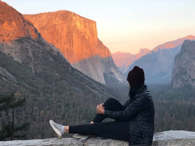 a woman looking at the mountains