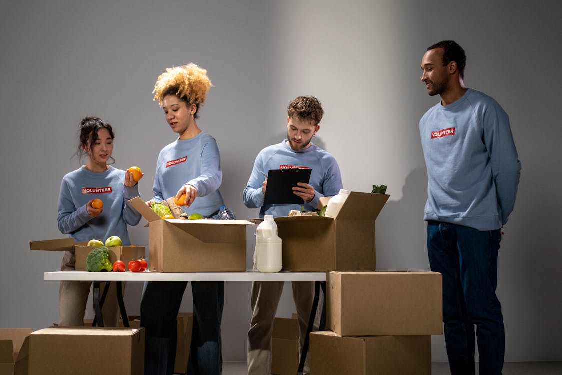Free Volunteers Boxing Foods to Be Distributed Stock Photo