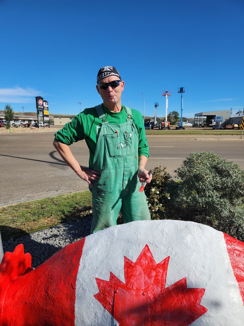A image of a dinosaur with the Canadian flag painted on it