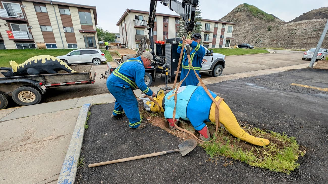 A image of a dinosaur being moved
