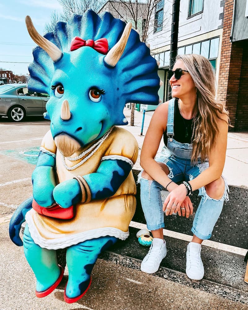 A image of a dinosaur sitting with a person 