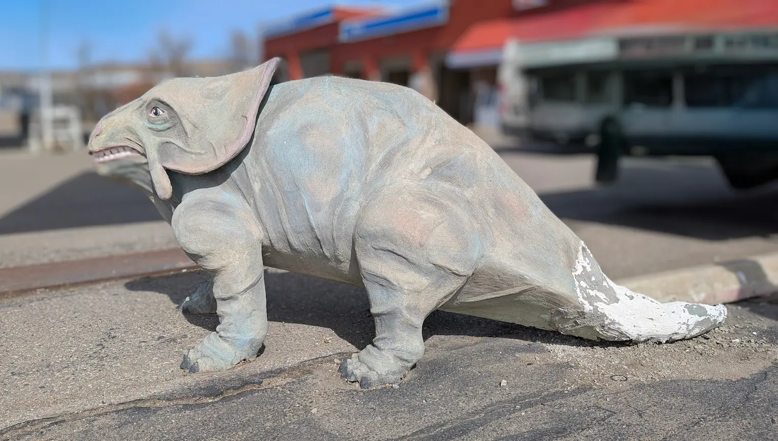 A image of a dinosaur statue Ester