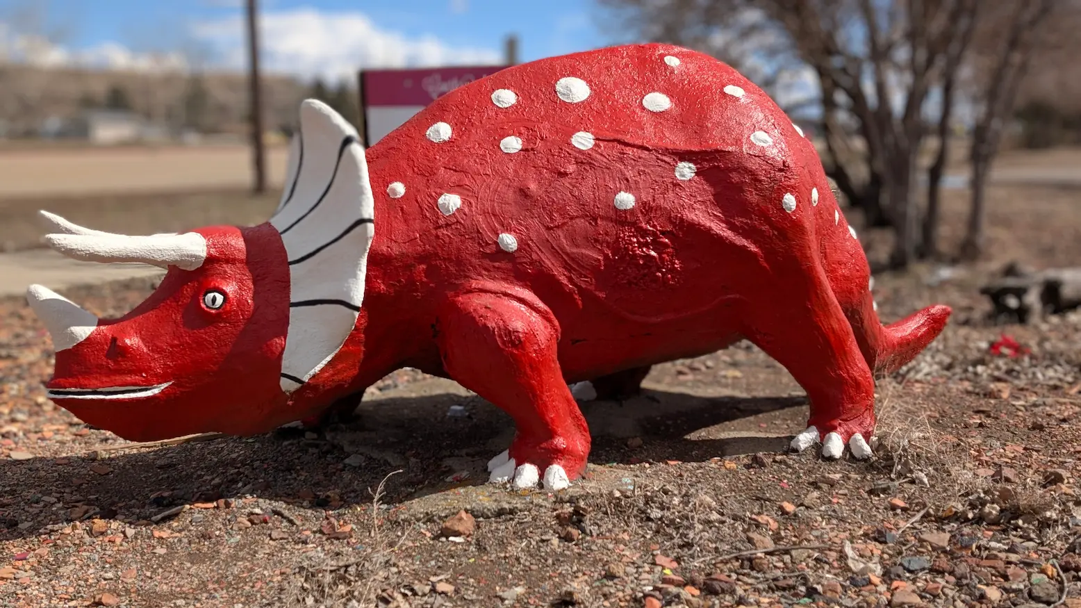 A image of a dinosaur statue Cooper