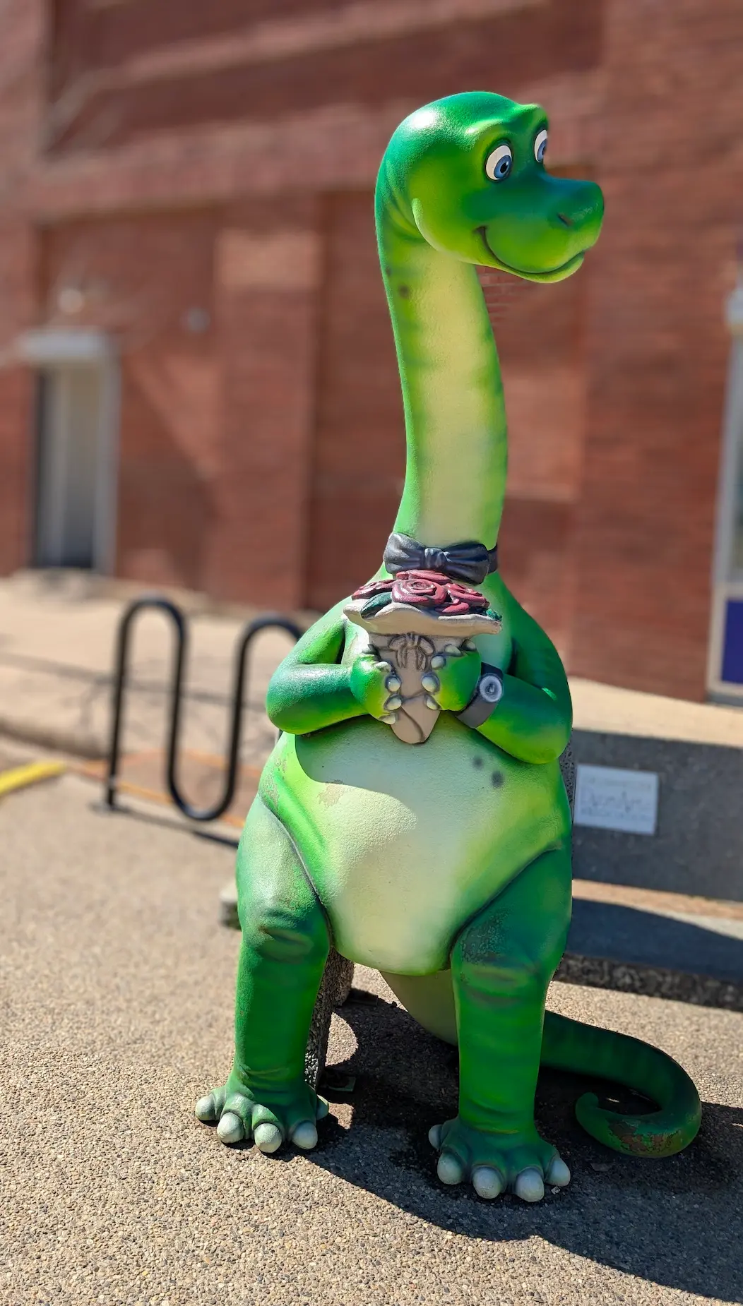 A image of a dinosaur statue Gus