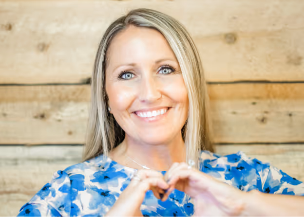 Photo of a lady making a heart symbol on her hands at Tower Hill First Presbyterian Church
