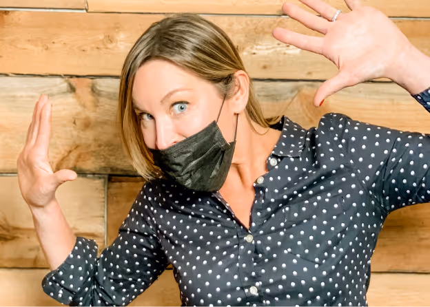 Photo of a lady wearing a black mask and putting her hands up at Tower Hill First Presbyterian Church