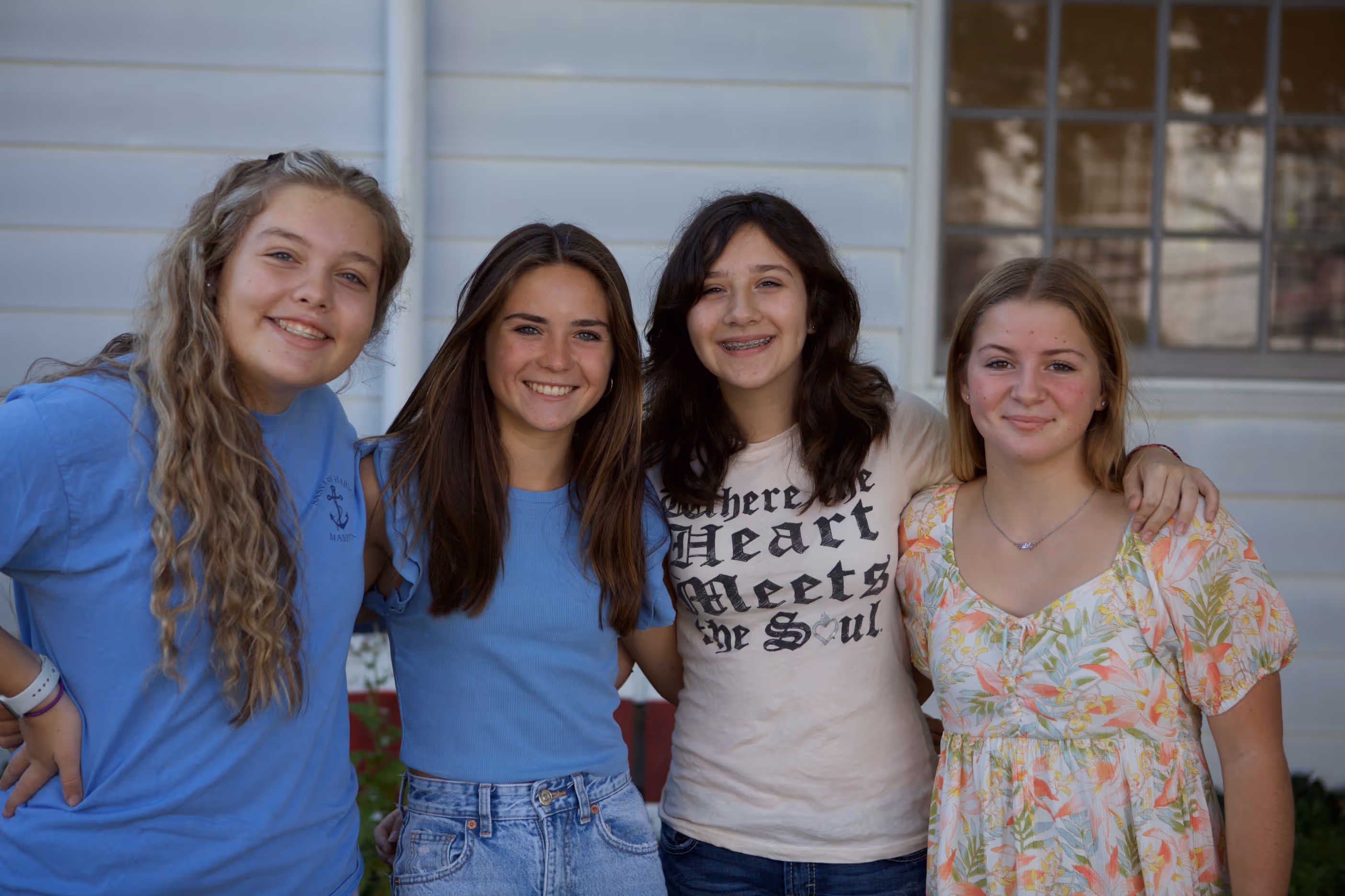 image of four high school girls smiling for a photo at Towerhill Church