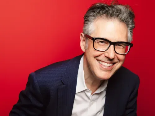 This American Life host, Ira Glass on a red background.