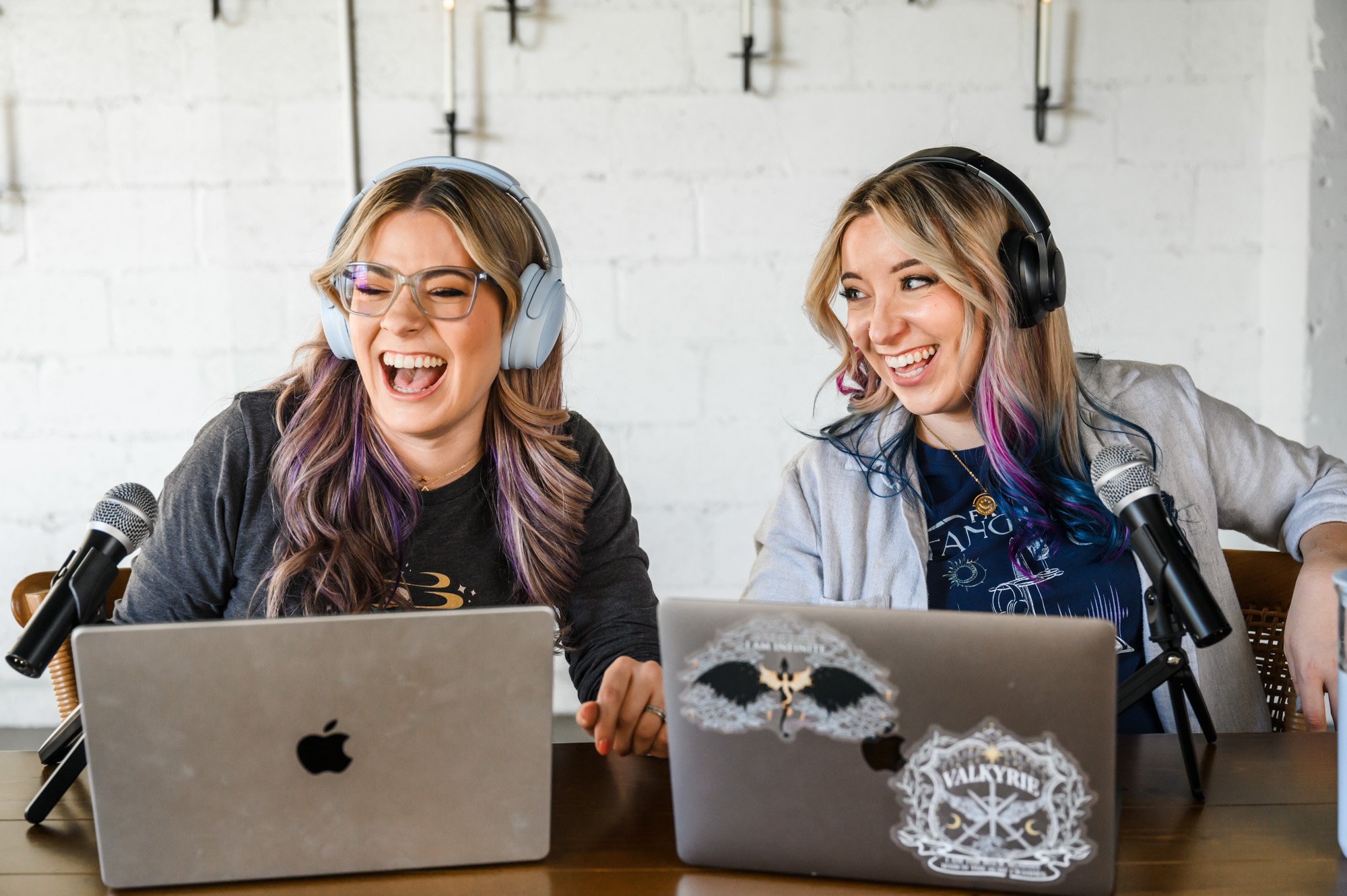 Fantasy Fangirls hosts, Nicole and Lexi, laugh while recording an episode of their podcast.