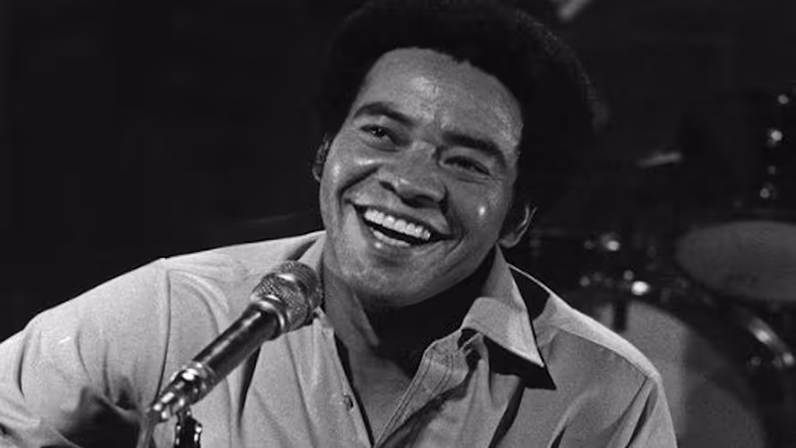 Bill Withers performing onstage.