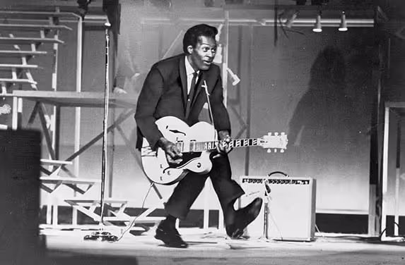 Chuck Berry doing his famous duck walk.
