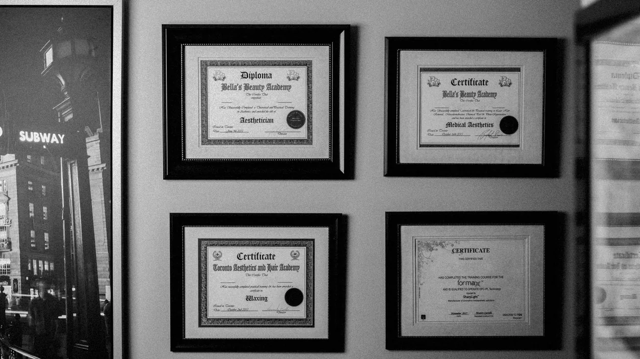 Black and white photo of framed certificates