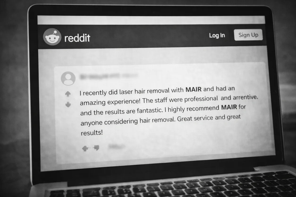 A laptop screen showing a Reddit post recommending MAIR for laser hair removal
