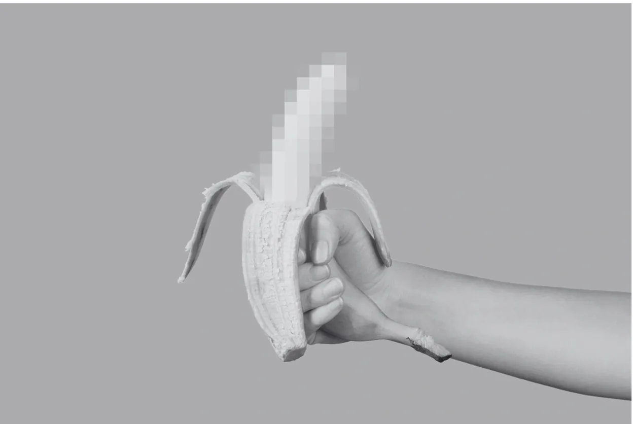A hand holding a partly peeled banana with its tip playfully pixelated