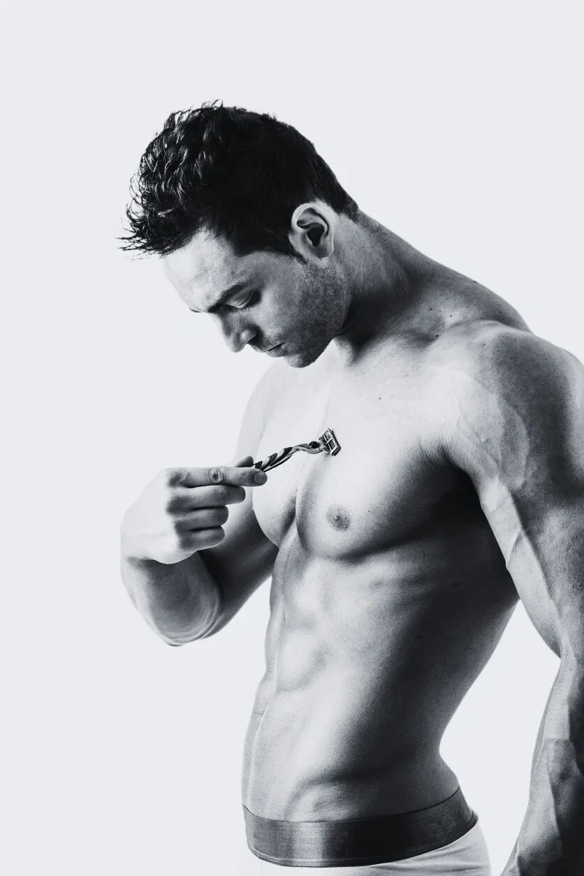 male shaving body with razor