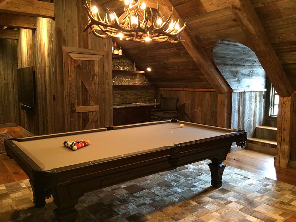 tan brown pool table with antler billiard lighting