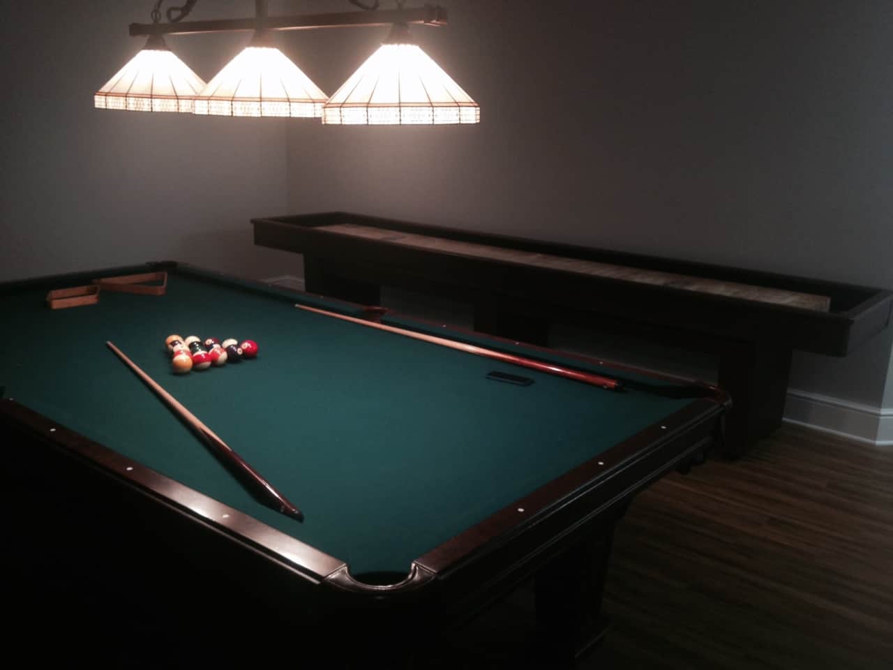 green pool table with billiard lighting