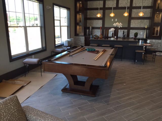 tan brown pool table and bar stools