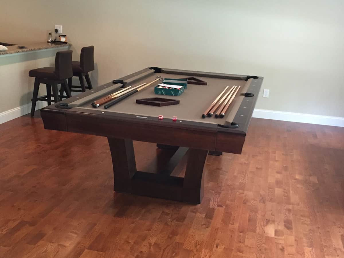 brown pool table and bar stools