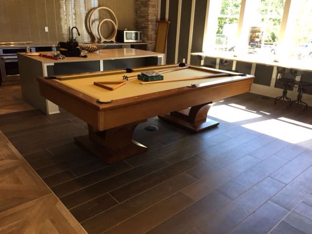 yellow pool table on a hardwood floor