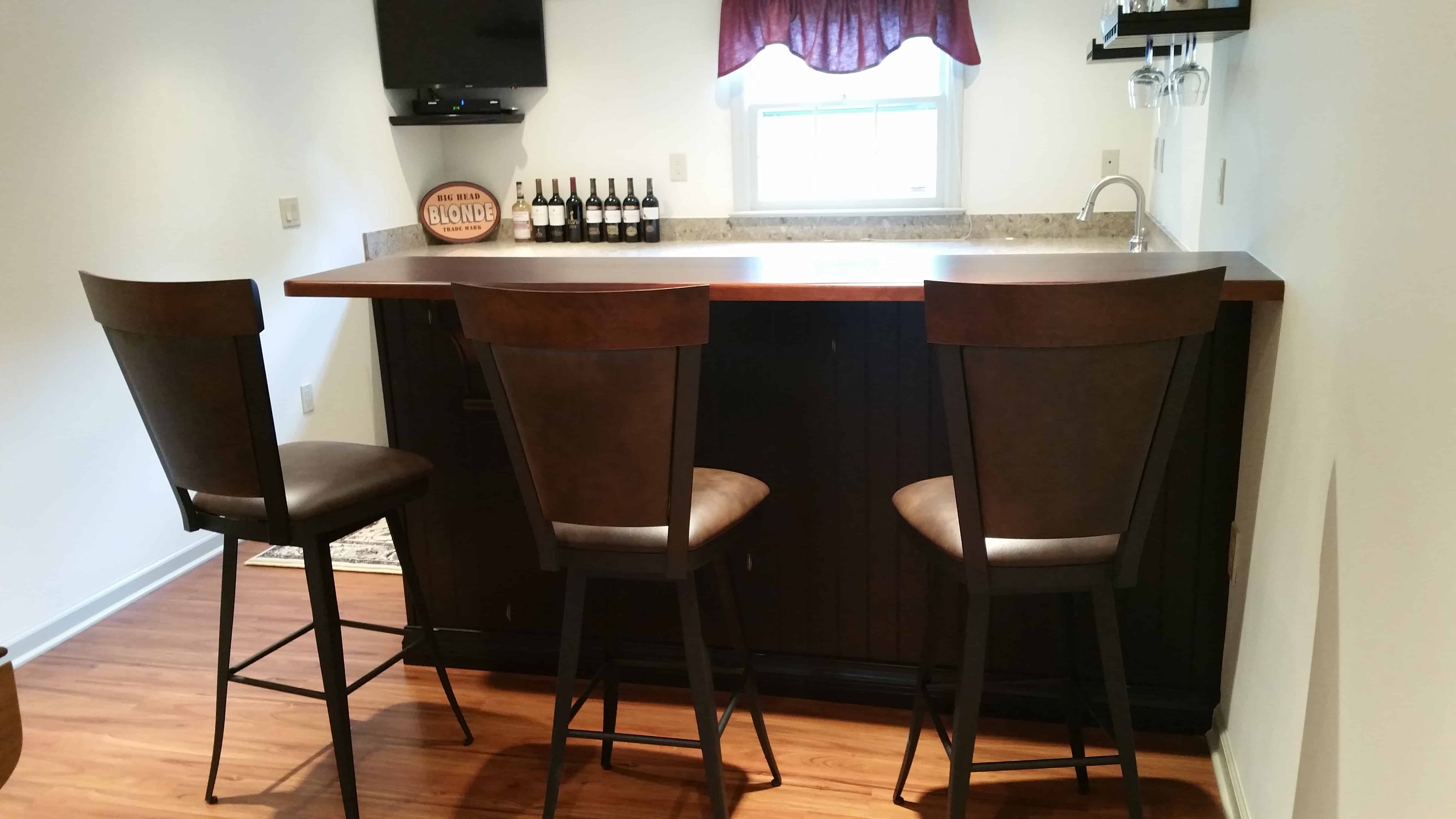 three brown bar stools