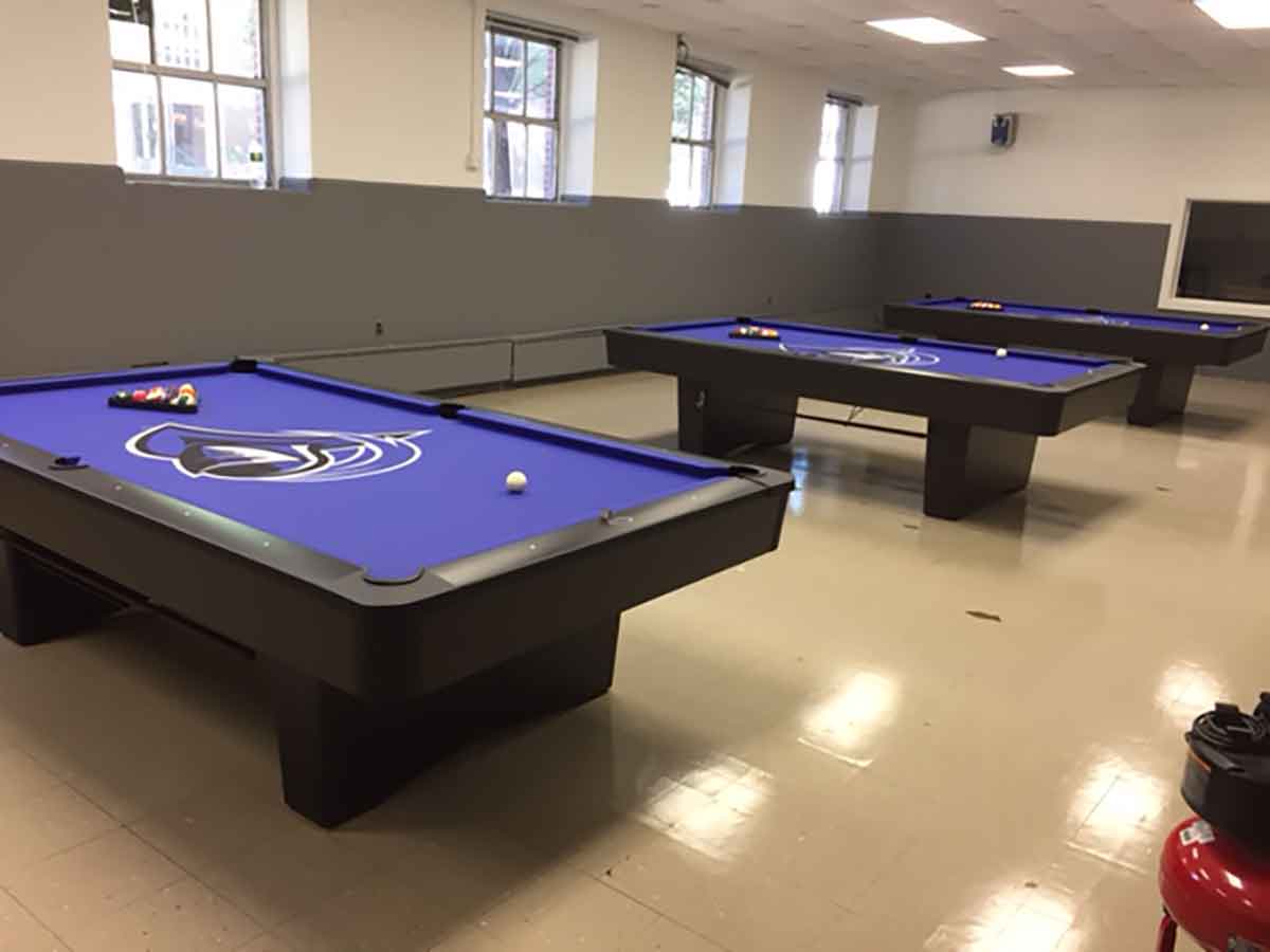 three purple pool tables