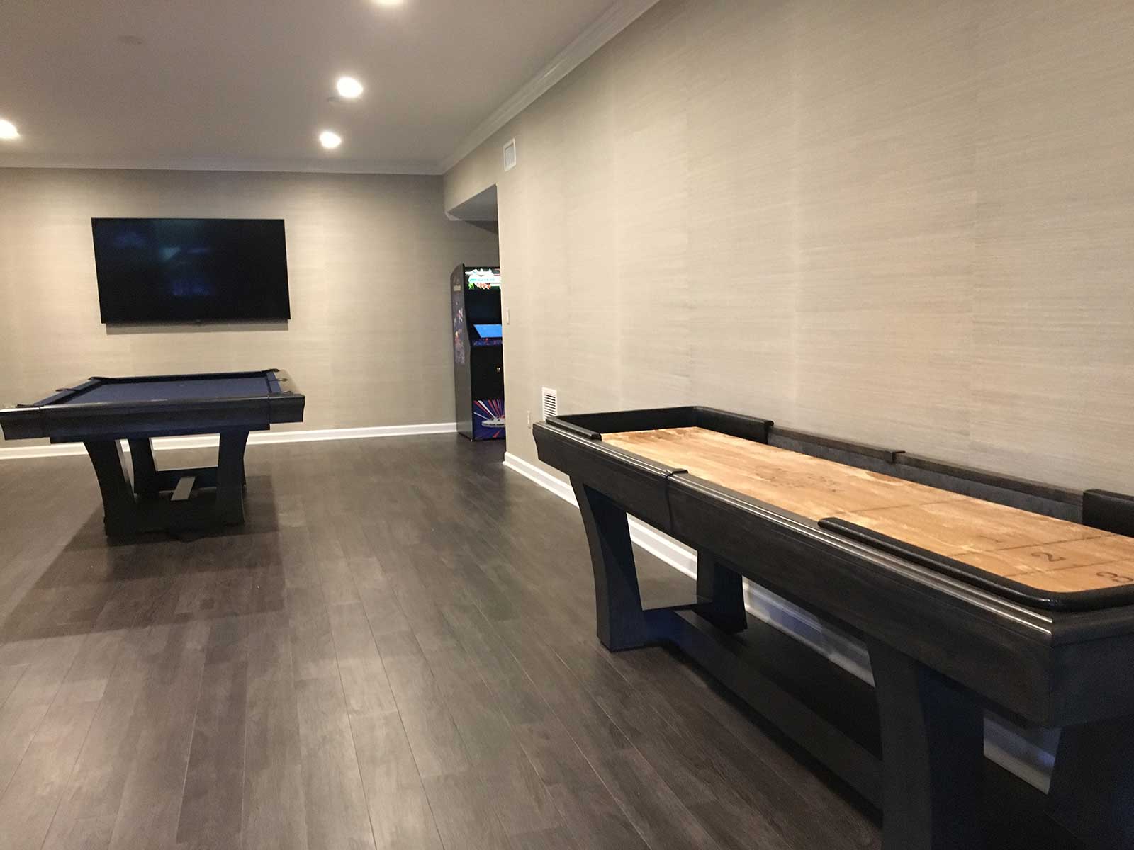 blue pool table, shuffleboard and arcade machine game room