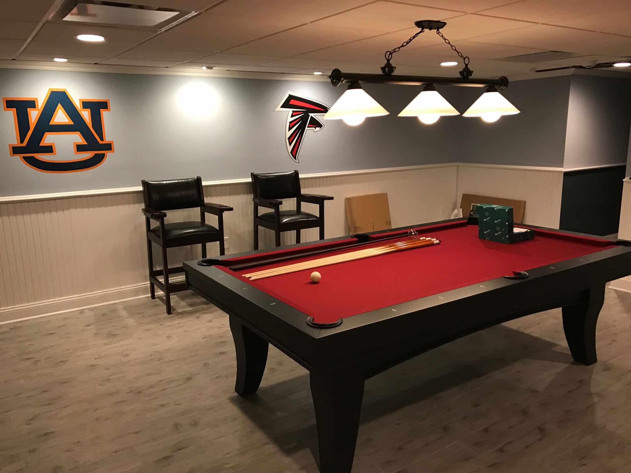 red pool table with falcons poster