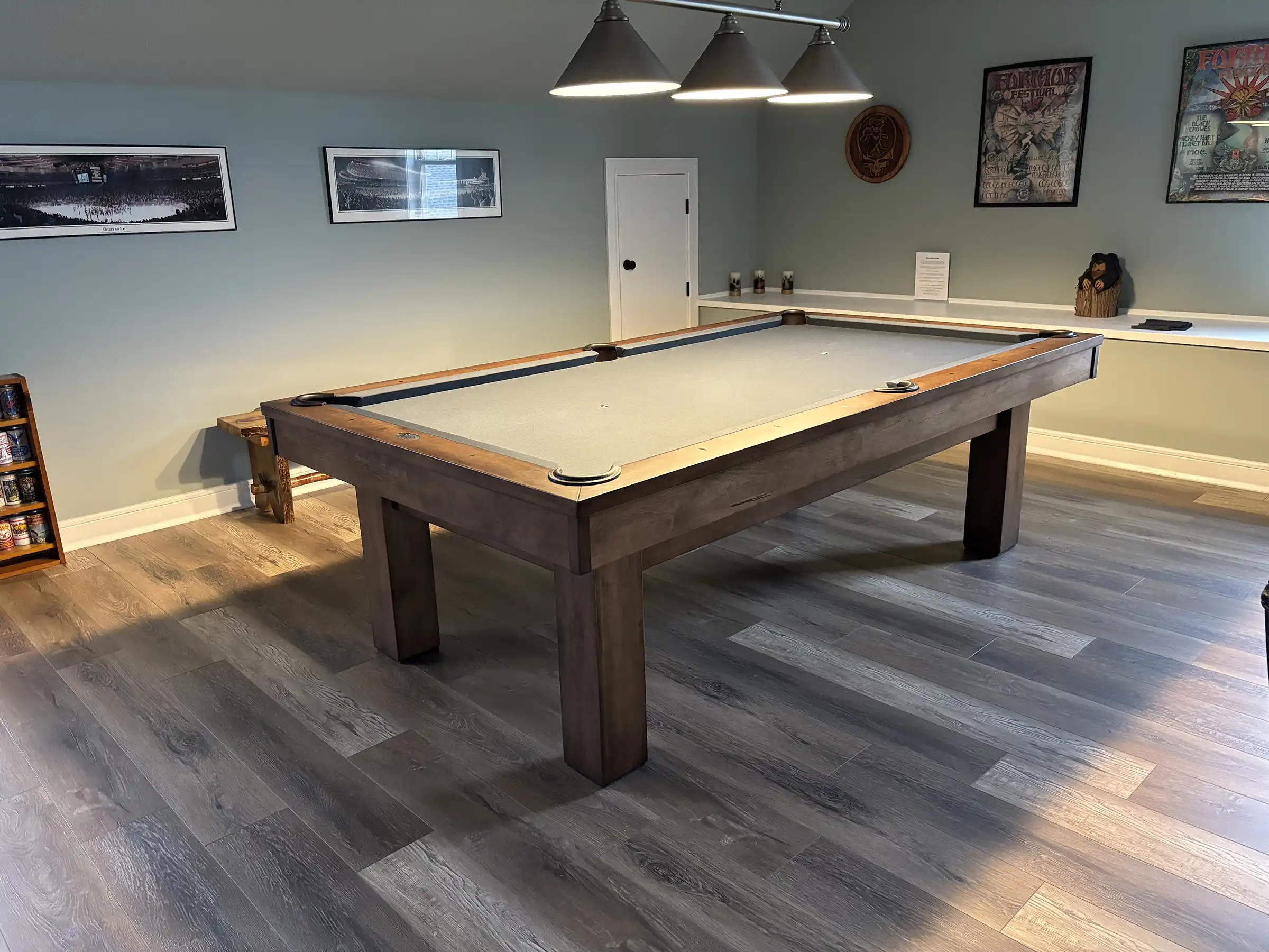 Olhausen pool table featuring a rustic rough-sawn wood finish and grey (gray) felt, installed in a modern game room.